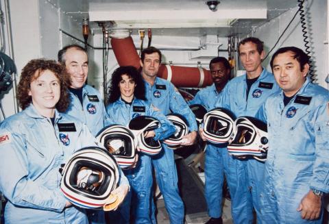 In this photo from Jan. 9, 1986, the Challenger crew takes a break during countdown training at NASA's Kennedy Space Center. Left to right are Teacher-in-Space payload specialist Sharon Christa McAuliffe; payload specialist Gregory Jarvis; and astronauts Judith A. Resnik, mission specialist; Francis R. (Dick) Scobee, mission commander; Ronald E. McNair, mission specialist; Mike J. Smith, pilot; and Ellison S. Onizuka, mission specialist.